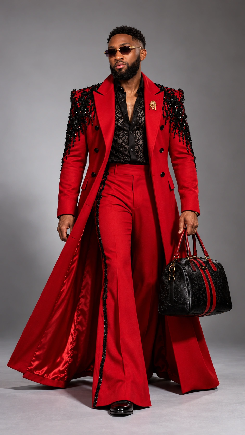 Merveil in a red embellished long coat and flared trousers holding a black and red bag